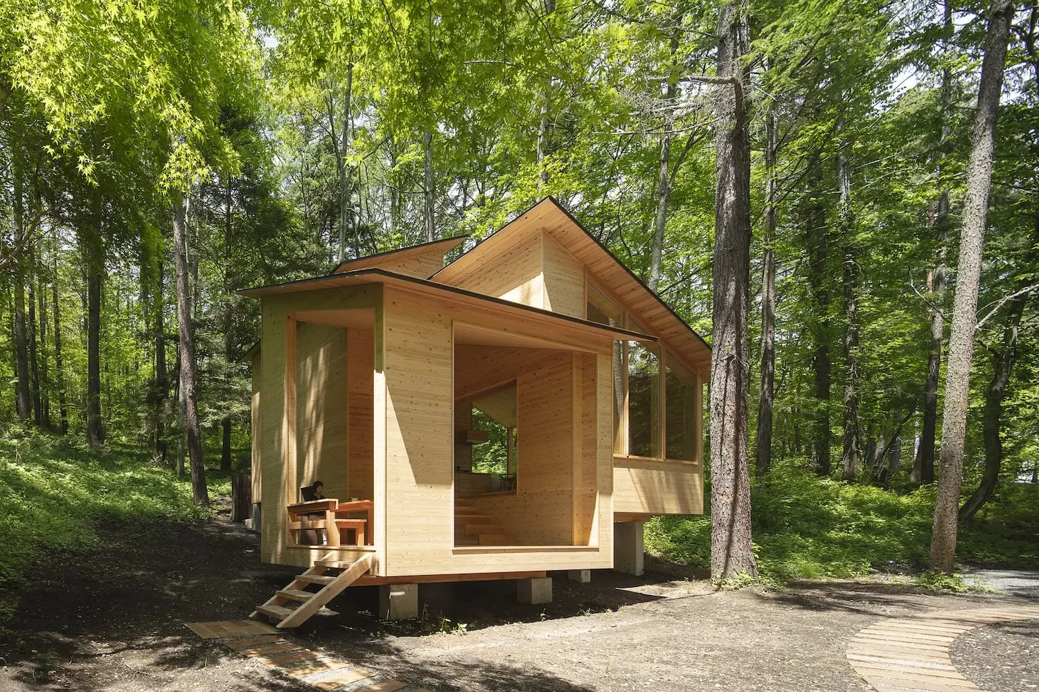 Forest Hut by K+S Architects elevated among the trees in Karuizawa, Japan
