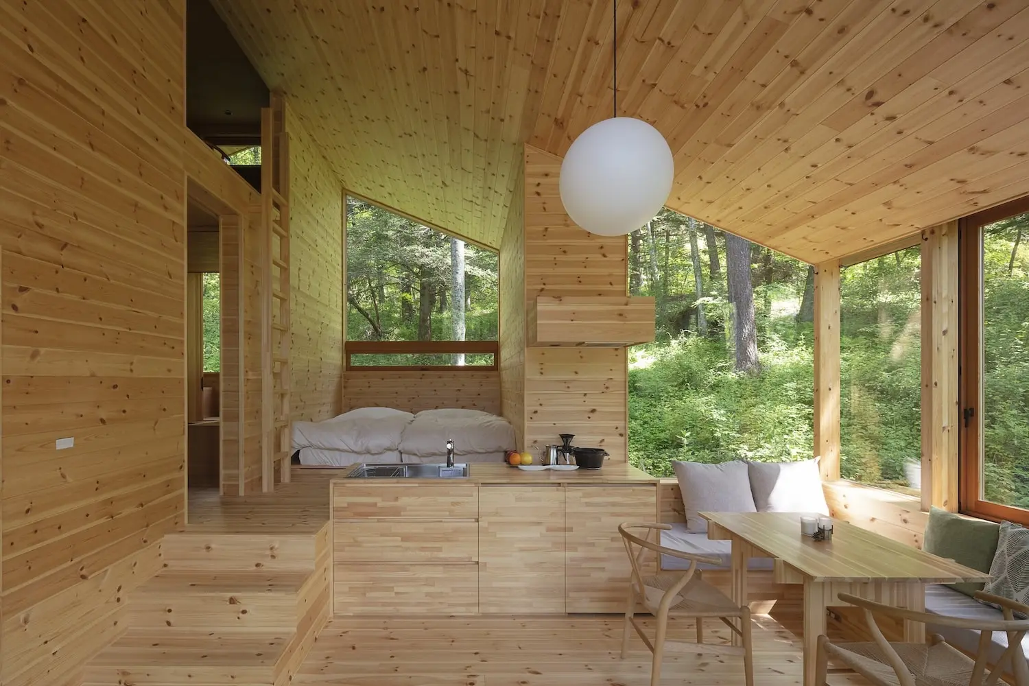 The Forest Hut's minimal timber interior opening onto the surrounding woodland